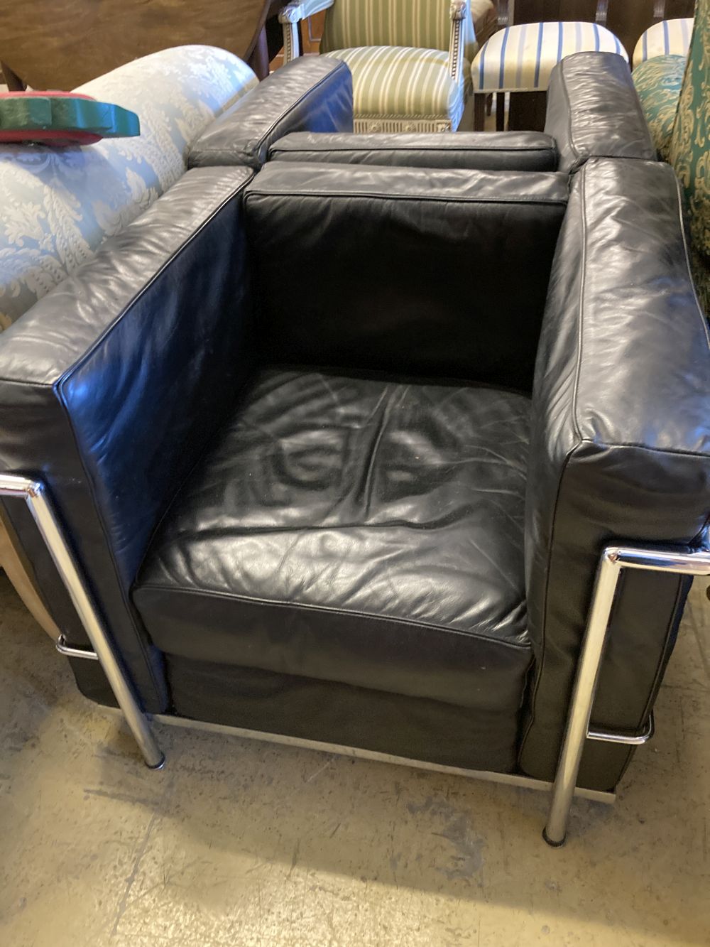 A pair of Le Corbusier style leather and chrome chairs, width 76cm, depth 70cm, height 65cm
